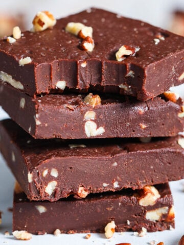 Stack of Paleo Chocolate Fudge bars, the top one missing a bite.