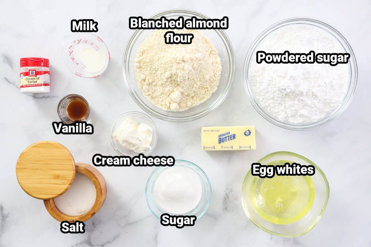 Ingredients for Vanilla Macarons: milk, blanched almond flour, powdered sugar, cream of tartar, vanilla, cream cheese, butter, egg whites, sugar, and salt.